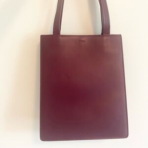 Leather baggu in cranberry color - fair condition